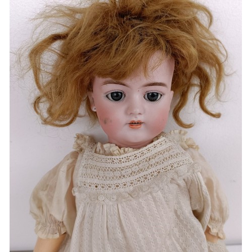 907 - A German bisque head doll, with a jointed body and millefiori glass eyes, 42 cm high Provenance:&nbs... 