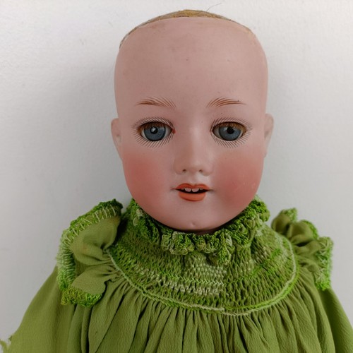 910 - A German Armand Marseille bisque head doll, No. 390, with a jointed body and millefiori glass eyes, ... 