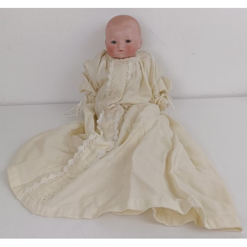 911 - A German bisque head baby doll, 36 cm high, with a cloth and composite body, 30 cm and another (2) P... 