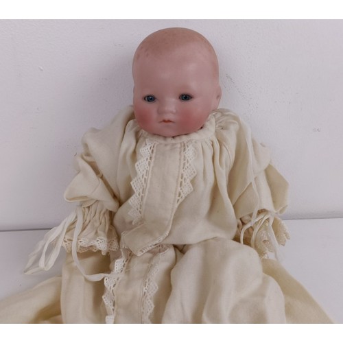 911 - A German bisque head baby doll, 36 cm high, with a cloth and composite body, 30 cm and another (2) P... 