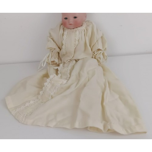 911 - A German bisque head baby doll, 36 cm high, with a cloth and composite body, 30 cm and another (2) <...