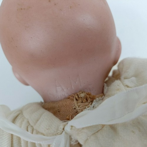 911 - A German bisque head baby doll, 36 cm high, with a cloth and composite body, 30 cm and another (2) P... 