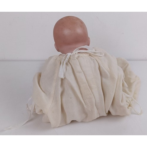 911 - A German bisque head baby doll, 36 cm high, with a cloth and composite body, 30 cm and another (2) P... 