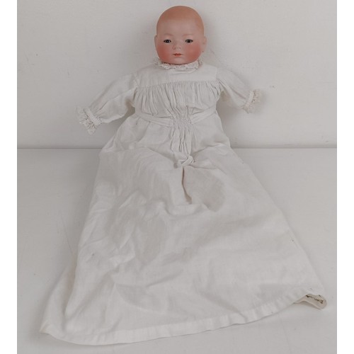 911 - A German bisque head baby doll, 36 cm high, with a cloth and composite body, 30 cm and another (2) P... 