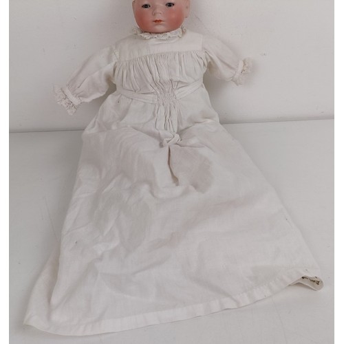 911 - A German bisque head baby doll, 36 cm high, with a cloth and composite body, 30 cm and another (2) P... 