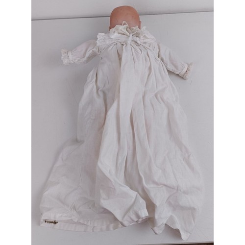 911 - A German bisque head baby doll, 36 cm high, with a cloth and composite body, 30 cm and another (2) P... 