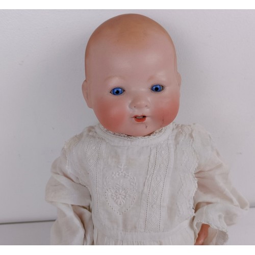 912 - An Armand Marseille bisque head baby doll, with a composite and cloth body, 42 cm, and another (2) P... 