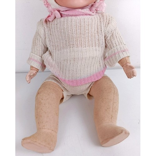 912 - An Armand Marseille bisque head baby doll, with a composite and cloth body, 42 cm, and another (2) P... 