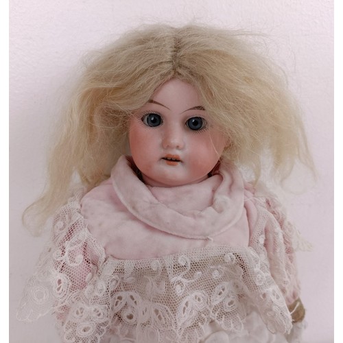 914 - A Continental bisque head doll, with a leather and porcelain body, 40 cm Provenance:  From a la... 