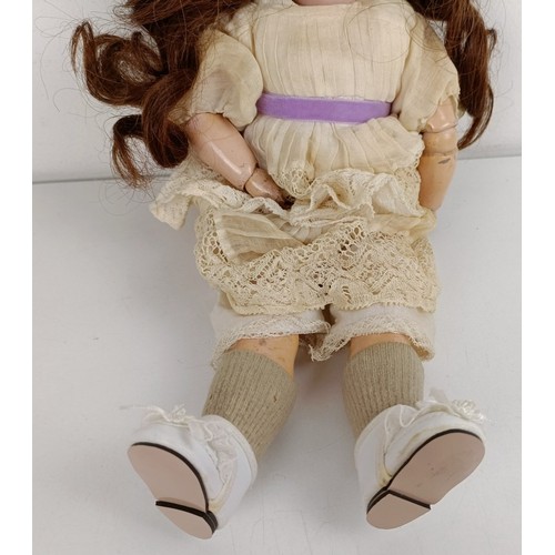 916 - A Simon & Halbig bisque head doll, with a jointed composite body and millefiori eyes, 34 cm Prov... 