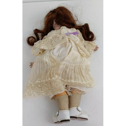 916 - A Simon & Halbig bisque head doll, with a jointed composite body and millefiori eyes, 34 cm Prov... 