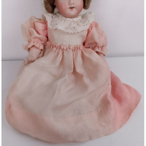 918 - A Continental bisque head doll, with a jointed body and millefiori glass eyes, 25 cm, and another 17... 