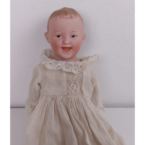 921 - A German bisque head doll, with a leather jointed body, 23 cm Provenance:  From a large single ... 