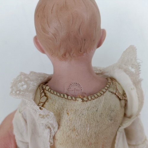 921 - A German bisque head doll, with a leather jointed body, 23 cm Provenance:  From a large single ... 