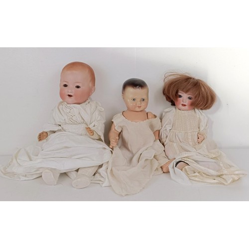 923 - A German Armand Marseille baby doll, with a cloth body, 40 cm, and two other dolls (3) Provenance:&n... 