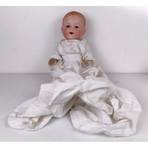 923 - A German Armand Marseille baby doll, with a cloth body, 40 cm, and two other dolls (3) Provenance:&n... 