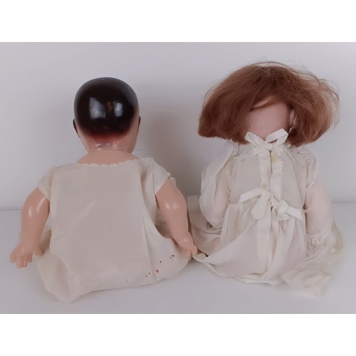 923 - A German Armand Marseille baby doll, with a cloth body, 40 cm, and two other dolls (3) Provenance:&n... 