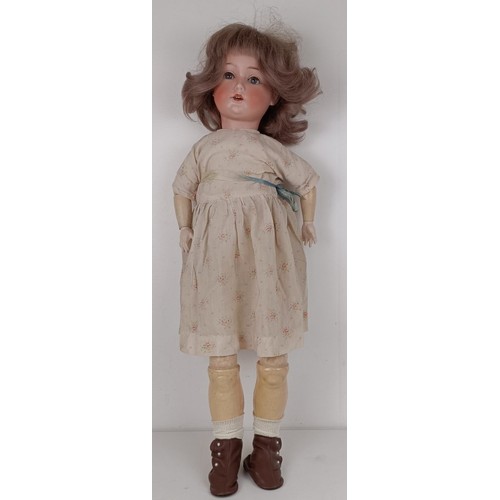 925 - A German Herm Steiner bisque head doll, No 20, with a composite body and millefiori glass eyes, 70 c...