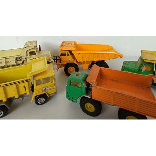 990 - Assorted play worn toy dumper trucks and other trucks, and a Dinky Supertoys box only, No 959