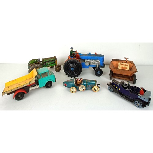 992 - A tinplate model tractor and other play worn toys (box)