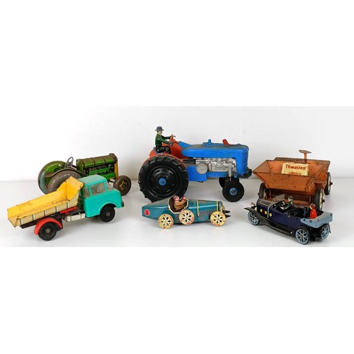 992 - A tinplate model tractor and other play worn toys (box)