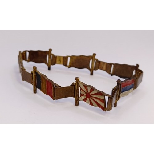 591 - A gilt metal and enamel novelty bracelet, decorated flags of World War II Allies, and a ARP badge (2... 