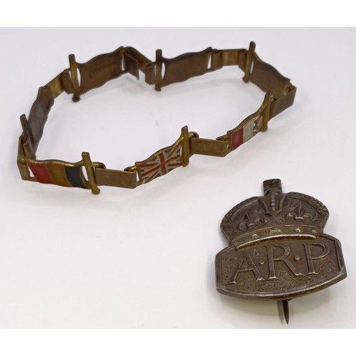 591 - A gilt metal and enamel novelty bracelet, decorated flags of World War II Allies, and a ARP badge (2... 