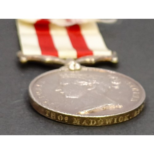 573 - An Indian Mutiny medal, awarded to Thos M Madgwick 82nd Regiment, with copy documentation