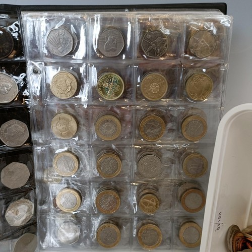 353 - A group of assorted modern commemorative £2, £1, 50p, other coins and crowns, in an albu...