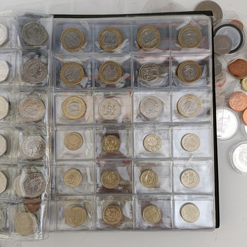 353 - A group of assorted modern commemorative £2, £1, 50p, other coins and crowns, in an albu...