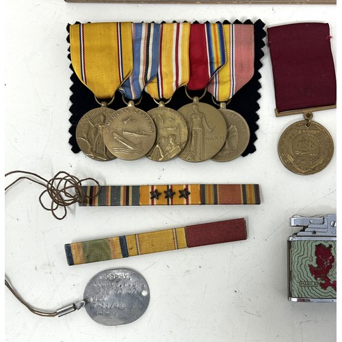 563 - The dog tags, medals, photographs, cigarette lighters and other items belonging to Donald Farr Murph... 