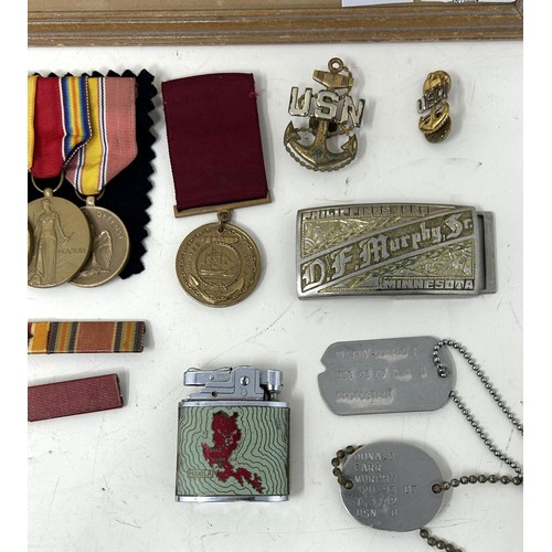 563 - The dog tags, medals, photographs, cigarette lighters and other items belonging to Donald Farr Murph... 