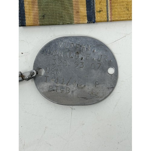 563 - The dog tags, medals, photographs, cigarette lighters and other items belonging to Donald Farr Murph... 