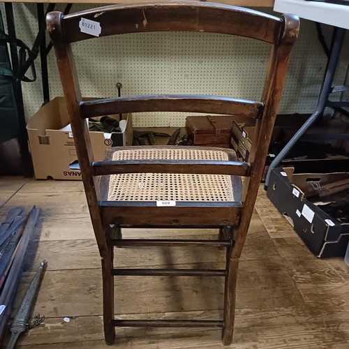 509 - A small stained beech campaign folding chair, stamped with an MOD crow's foot