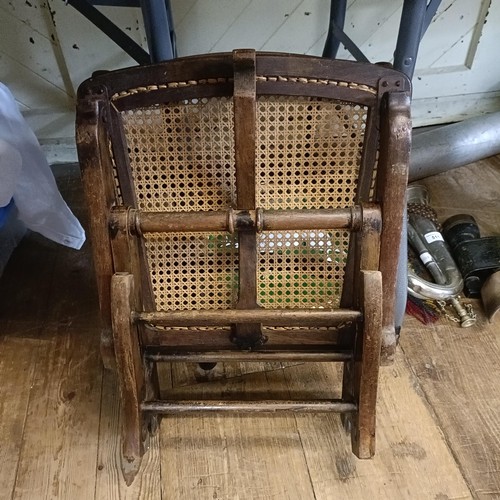 509 - A small stained beech campaign folding chair, stamped with an MOD crow's foot