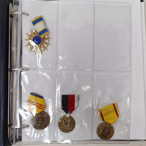 415 - A group of assorted American medals, in an album Provenance: On Instructions of the Family: Medals a... 