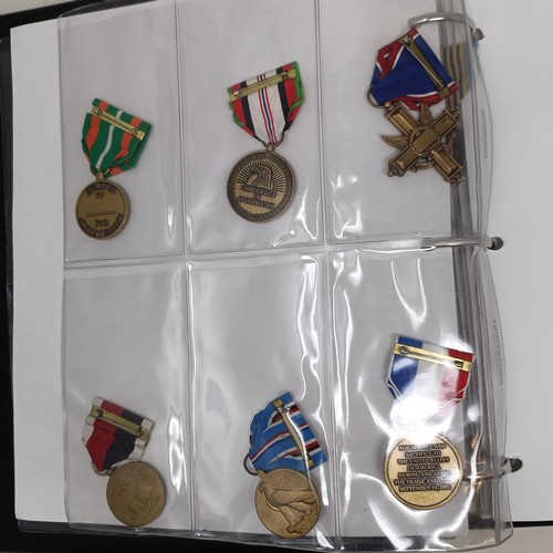 415 - A group of assorted American medals, in an album Provenance: On Instructions of the Family: Medals a... 