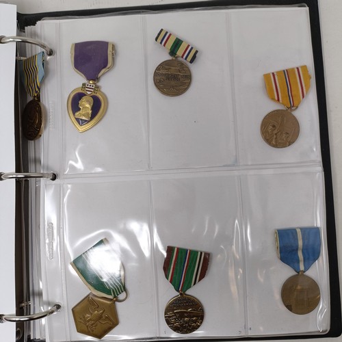 415 - A group of assorted American medals, in an album Provenance: On Instructions of the Family: Medals a... 