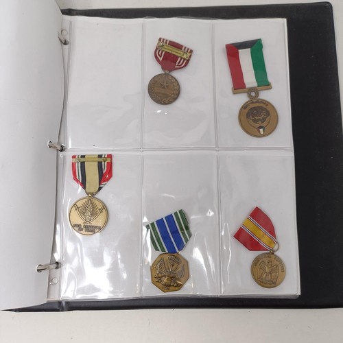 415 - A group of assorted American medals, in an album Provenance: On Instructions of the Family: Medals a... 