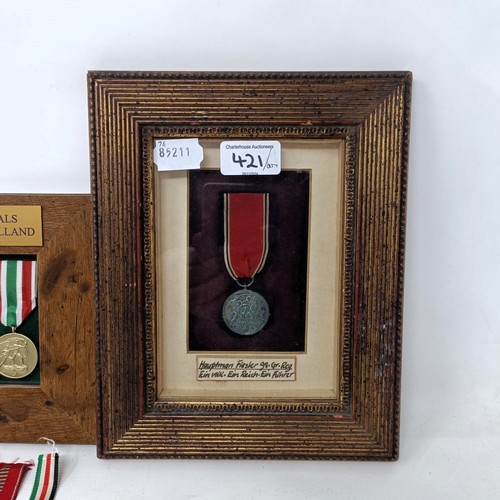 421 - A group of German medals, in two frames, and loose Provenance: On Instructions of the Family: Medals... 