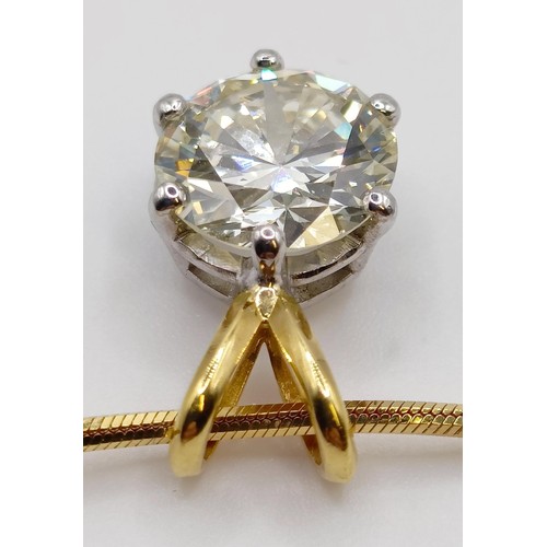 1602 - A 2ct diamond pendant, on an 18ct gold chain, with a white metal and diamond ring, which originally ... 