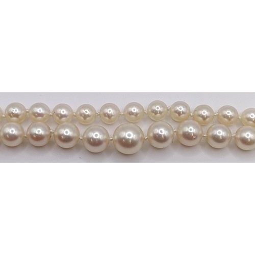 1605 - A cultured pearl necklace, with a diamond clasp, in a vintage jewellery box