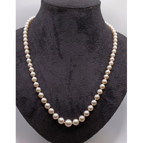 1605 - A cultured pearl necklace, with a diamond clasp, in a vintage jewellery box