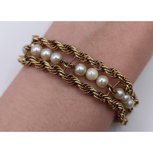 1606 - A yellow metal and cultured pearl bracelet