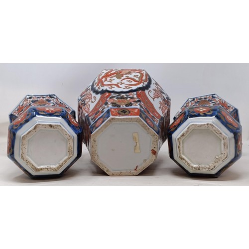 1057 - A pair of Japanese Imari vases, 22 cm high, and another similar, 23 cm high (3)