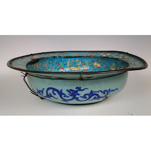 1065 - A Chinese enamel bowl, decorated flowers and butterflies, various losses, 42 cm diameter