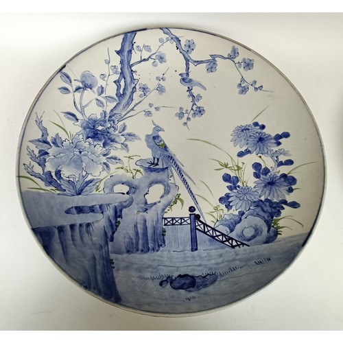 1073 - A Japanese bowl, decorated a bird in a landscape, 47 cm diameter, and another (2)