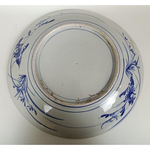 1073 - A Japanese bowl, decorated a bird in a landscape, 47 cm diameter, and another (2)