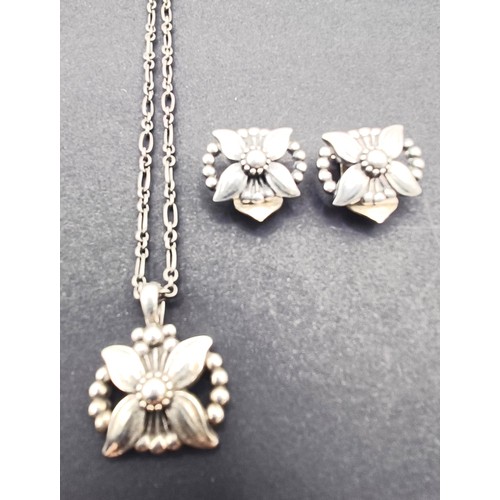 1710 - A Georg Jensen silver pendant, decorated flower, and a matching pair of earrings, 21.5 g, in a Georg... 