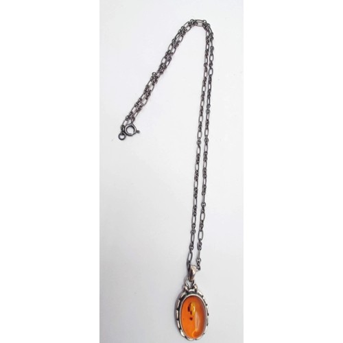 1711 - A Georg Jensen silver and amber coloured stone pendant, on a chain, and a pair of matching earrings ... 